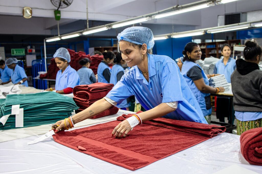 Group of women working in a textile factory folding towels and assembling products.